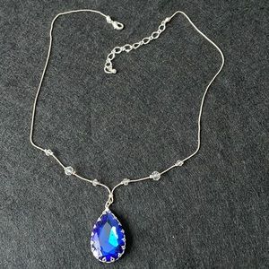 Silver necklace with royal blue rhinestone pendant.